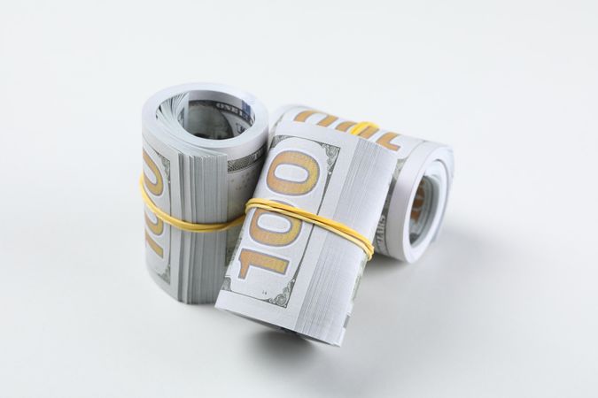 Stacks of American cash money, isolated on light background