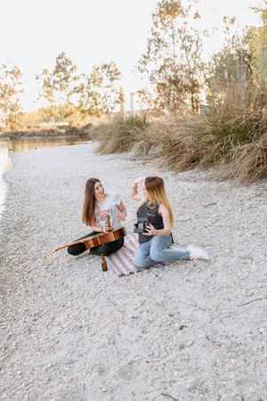 Girl friends taking selfie on beach