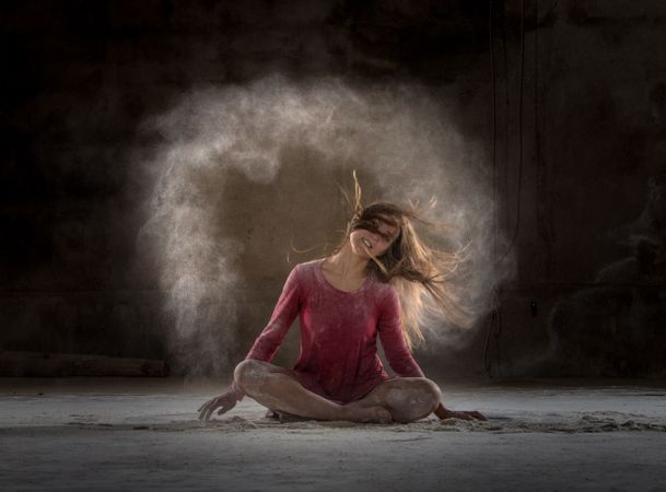 Young woman between fog in darkness