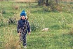 Cute boy standing on field