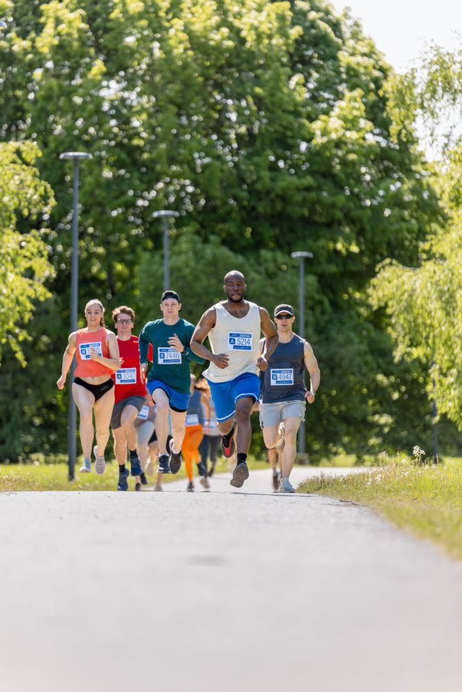 Wide Shot of Diverse Marathon Participants Competing in a Race for the Finish Line: Group of People Running Through Park Health Trail and Participating in a Marathon with Dedication