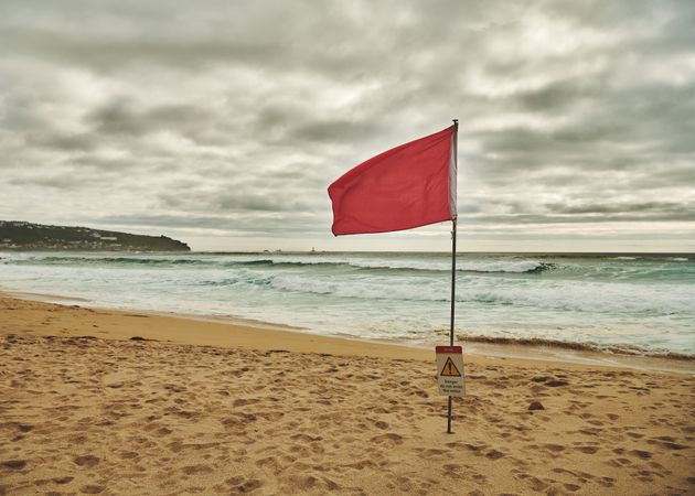 Red flag on a beach in Cornwall
