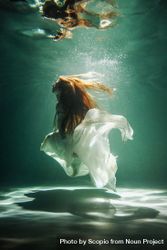 Underwater shot of woman wearing light dress 47L7kb