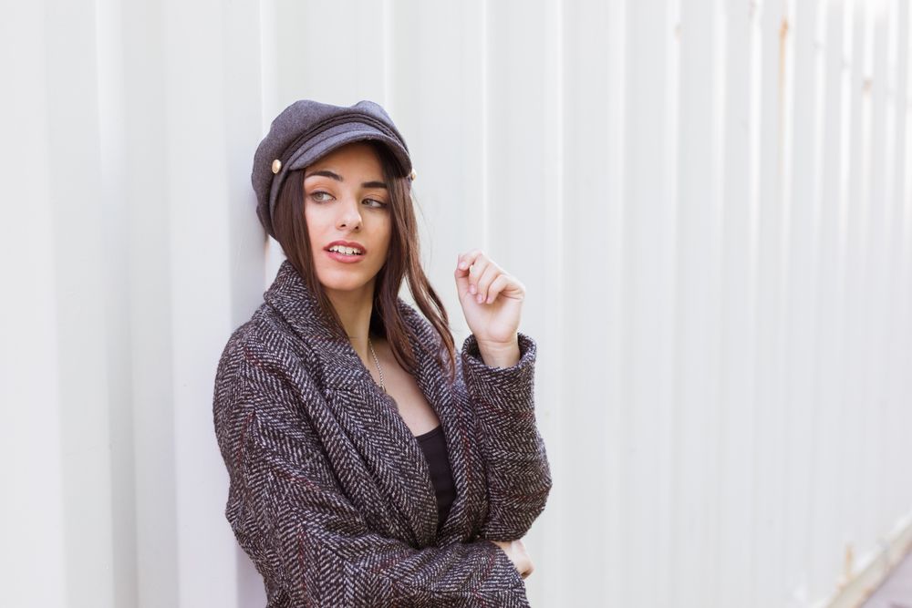 Charming Hispanic woman near wall