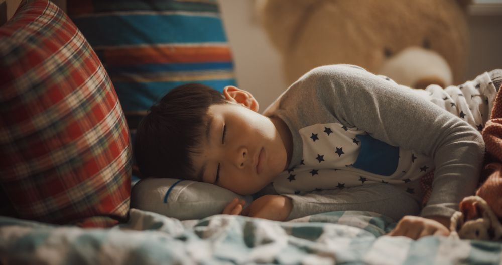 Portrait of a Cute Little Korean Boy Waking Up in His Cozy Room After a Good Night Sleep.