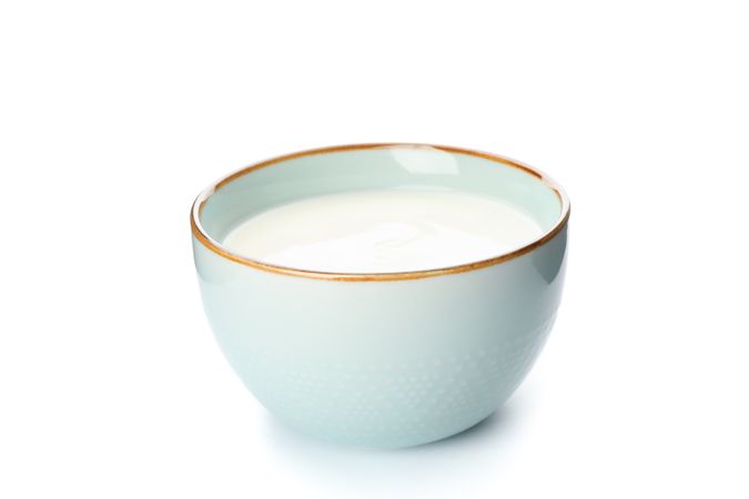 Bowl of sour cream yogurt isolated on plain background