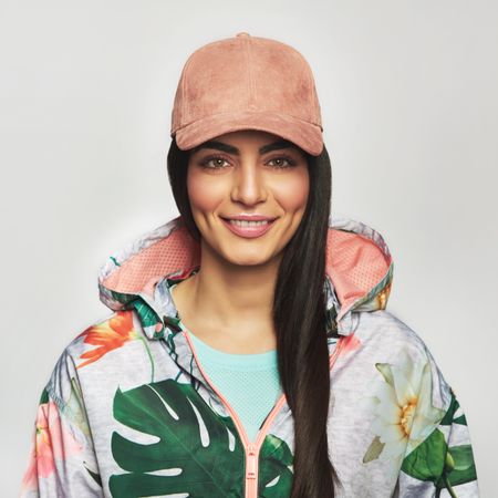 Happy and confident woman pictured in colorful printed floral hoodie