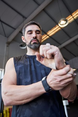 Confident sportsman in professional gymnastic pads
