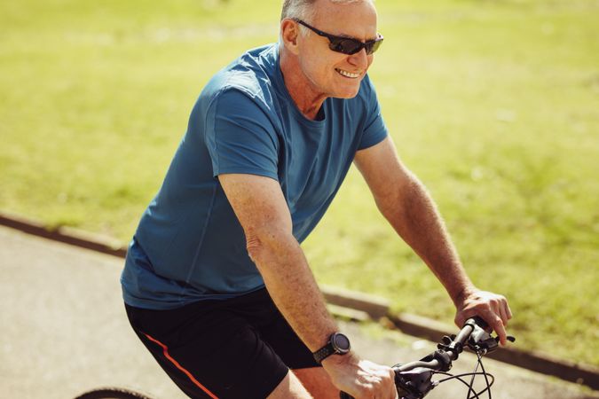 Portrait of a mature person riding a bicycle for fitness