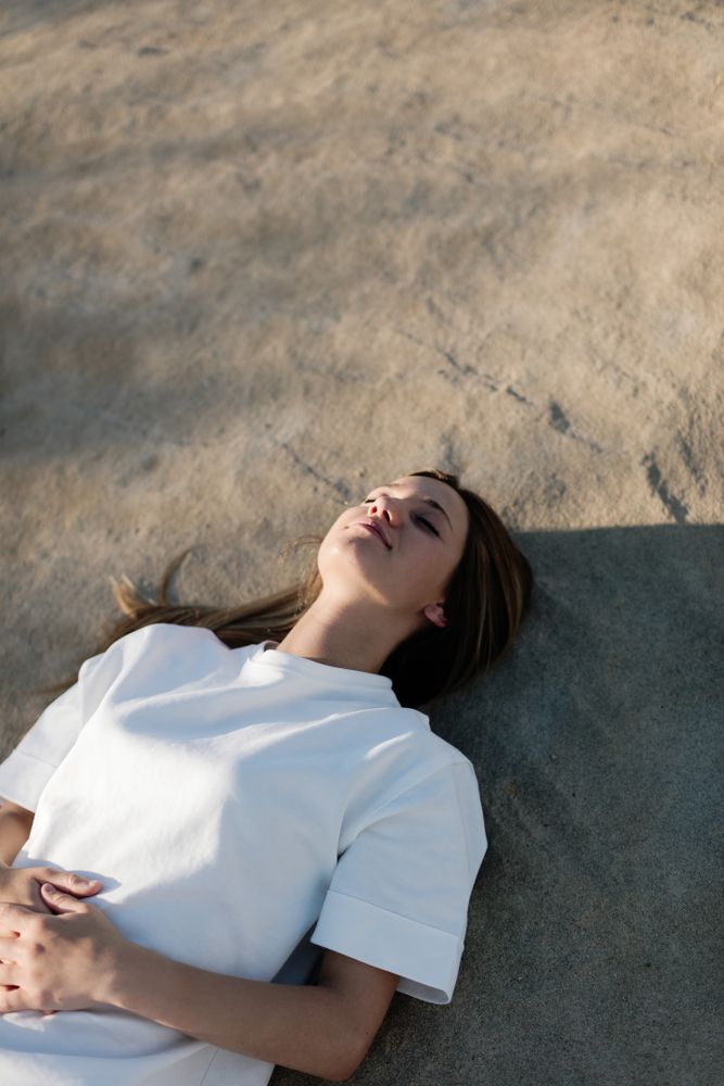 Young female lies on the sand