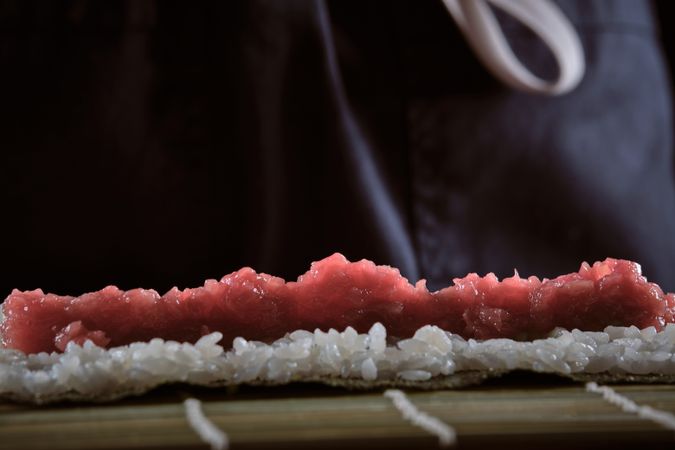 Male shushi man hands preparing different pieces of makis