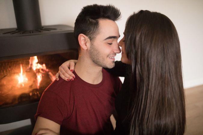 Couple sitting near fireplace