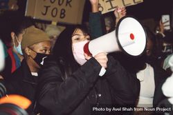 London, England, United Kingdom - March 16, 2021: Woman in face mask speaking into loudspeaker 49AGB4