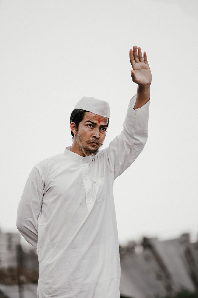 Man in light thobe waving his hand