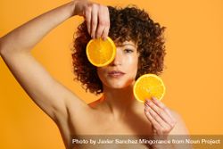 Woman with fresh orange slices in orange studio 5lVg3v