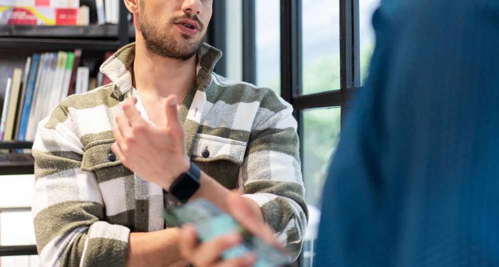 Banner of man talking to colleague in office