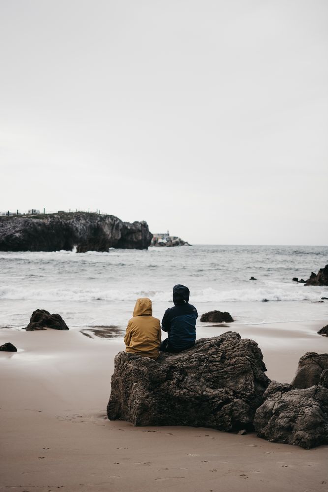 Anonymous people admiring waving sea
