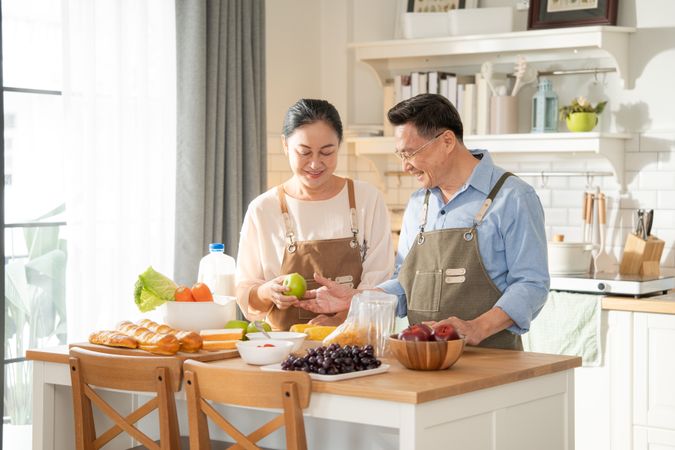 Asian couple cooking breakfast in the kitchen