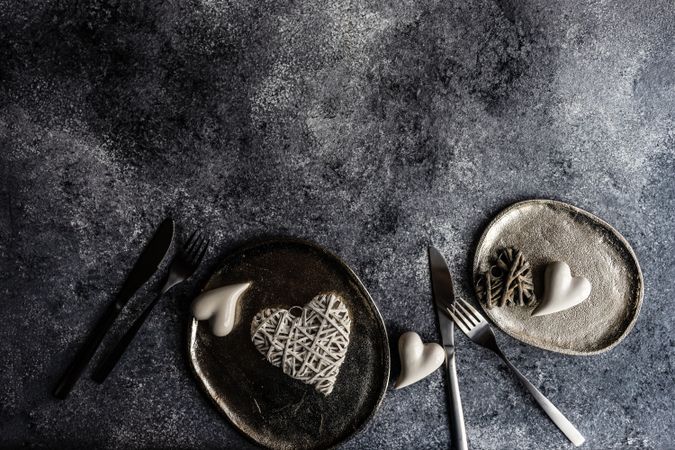 St. Valentines Day card concept with heart decorations on plates on grey counter