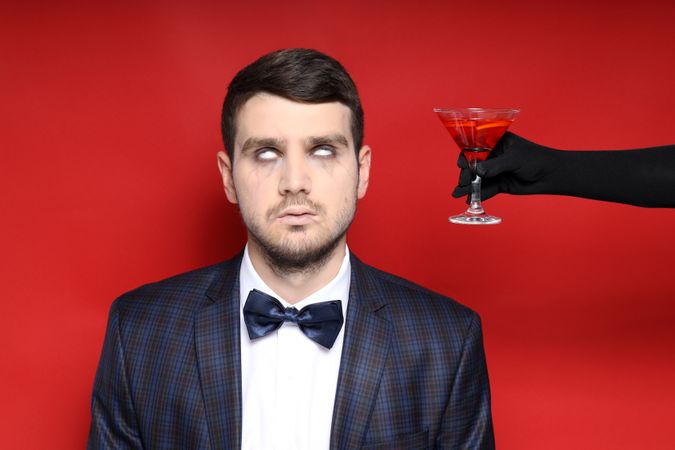 Concept of Halloween, young man on red background