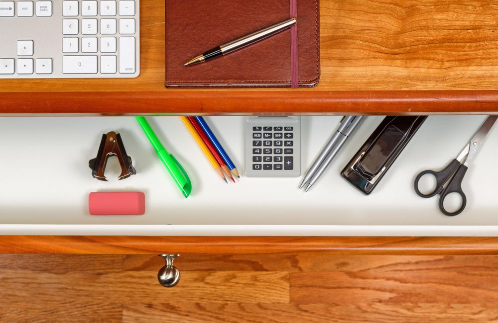 Desktop and open drawer with wooden floor underneath