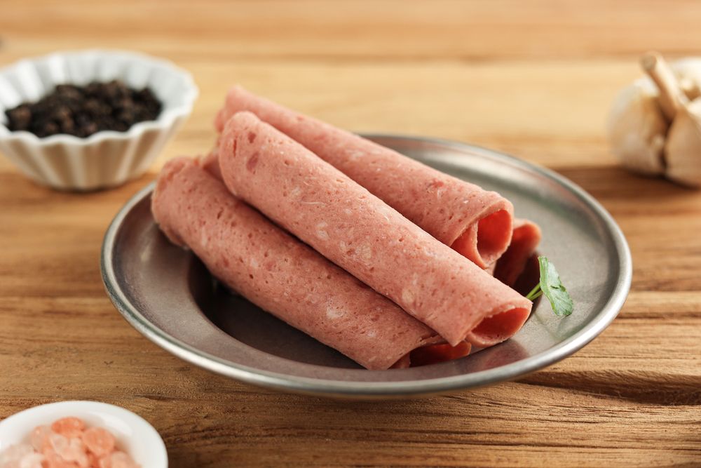 Rolled deli meat on plate