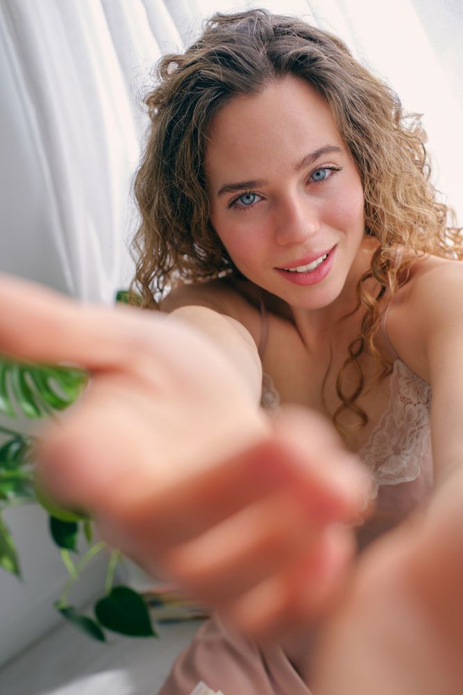 Smiling woman inviting to come in apartment