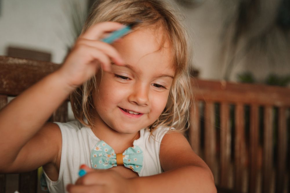 Girl coloring pictures at home