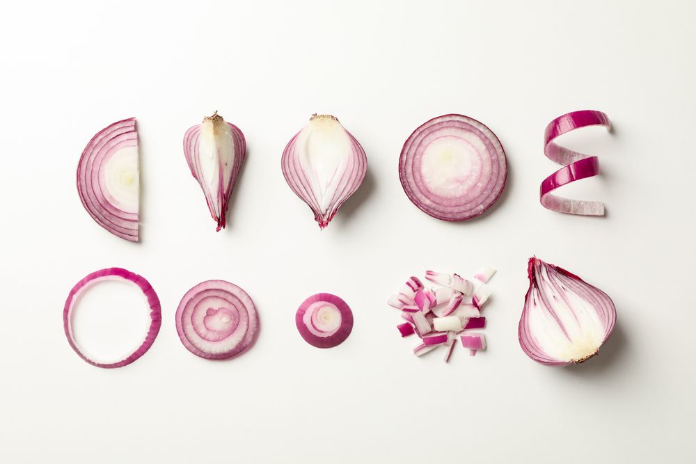Flat lay composition with red onion on neutral background