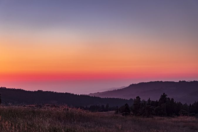 Colorful dusk over coastal hills