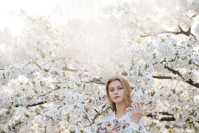 woman amidst white flowers