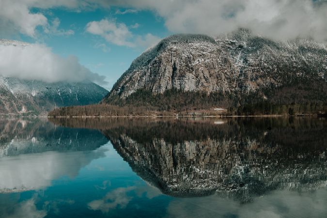 Perfect turquoise lake reflecting cloudy sky
