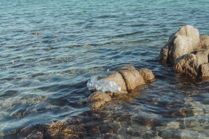 Plastic bottle lying on seashore