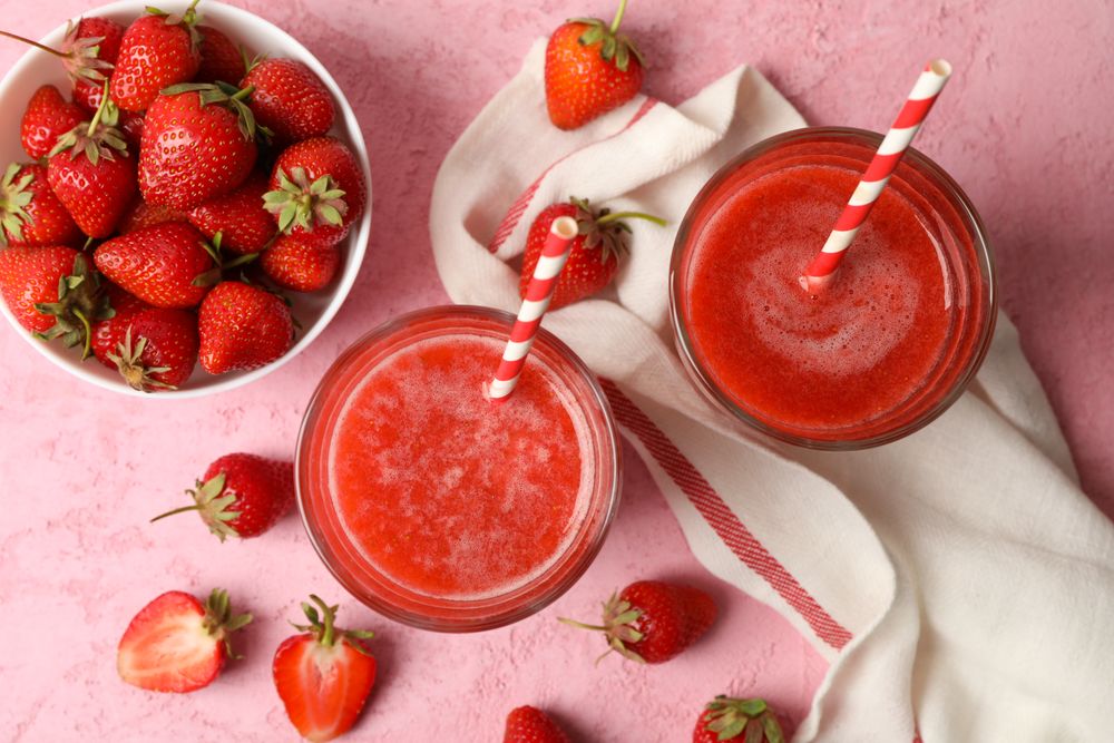 Composition with strawberry cocktails on pink table. Summer drink