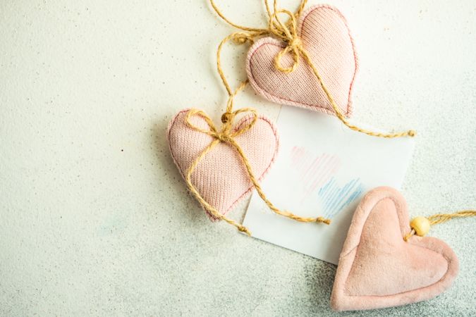 Valentine Day holiday card concept with felt pink heart decorations with copy space