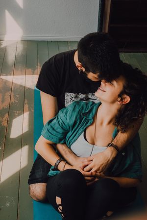 hipster couple kissing and cuddling at home