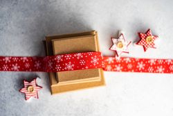 Top view of holiday gift boxes with red bow and star ornament