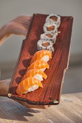 Appetizing sake sushi and rolls on tray