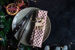 Top view of Christmas table setting with ornaments and dried orange slices