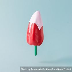 Red pepper with ice cream stick topped with pink syrup on pastel blue background 4BqPd5