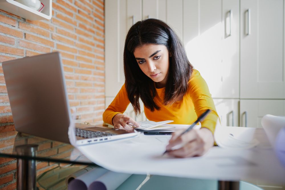Female of Persian descent working at home as an architect