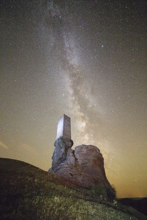 Ancient fort on rock in starry night