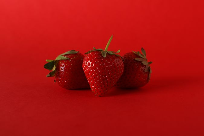 Tasty strawberry on red background. Summer berry