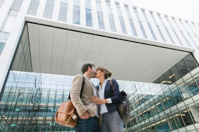 Businesspeople couple outside contemporary building