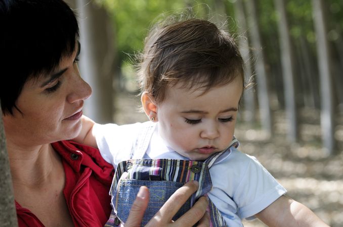 Woman holding cute baby girl close up