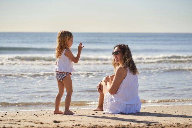 a woman with her daughter by the seashore