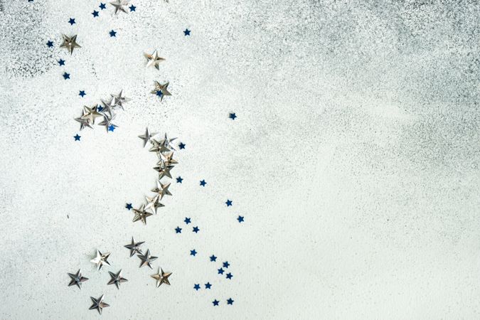 Festive Christmas card concept with silver star confetti decor