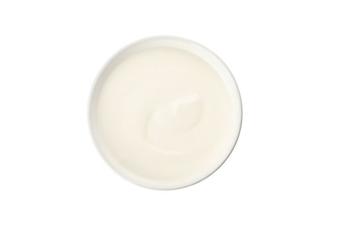 Bowl with cream yogurt isolated on light background