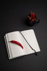 Chili peppers near notebook