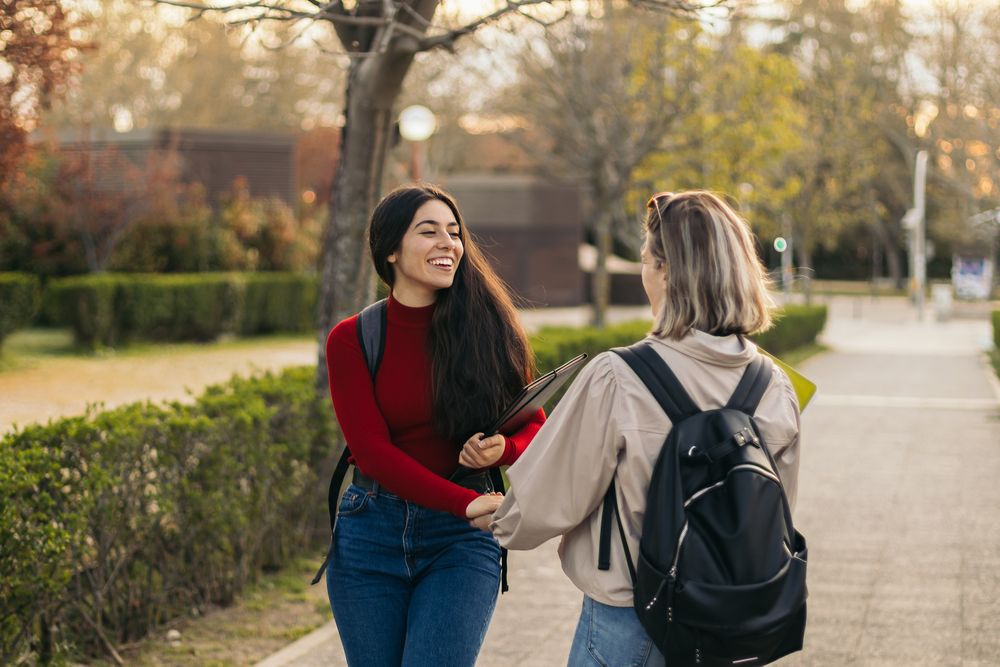 Back view of two student women talking and laughing